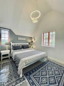 a bedroom with a large bed and a rug at Living The Breede - Sanborg in Malgas