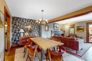 a dining room with a table and a couch at Saltbox 2A in Quechee