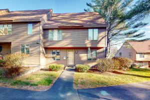 a house with a driveway in front of it at Saltbox 2A in Quechee