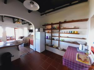 a room with a kitchen with a refrigerator and a table at Seaview Forest Cottage in Port St Johns
