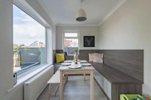 a dining room with a table and a large window at The Heights in Kingsdown