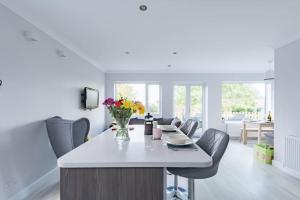 a kitchen and dining room with a table and chairs at The Heights in Kingsdown