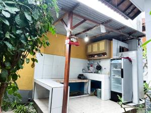 a small kitchen with a refrigerator and a table at Pandan Wangi in Nusa Lembongan