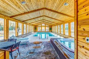 a swimming pool in a wooden house with a table and chairs at Timberbrook #110B in Brian Head