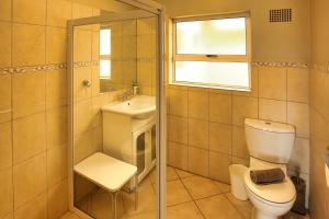 a bathroom with a toilet and a sink at Holiday Home Seemansrus in Langebaan