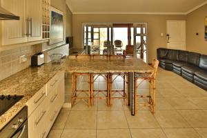 a kitchen with a table and chairs and a couch at Holiday Home Seemansrus in Langebaan