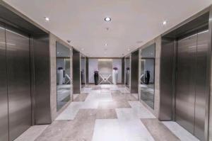 a hallway of a dressing room with glass doors at Orbi City in Batumi