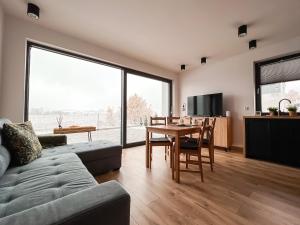a living room with a table and a dining room at Złote Wzgórza in Laski