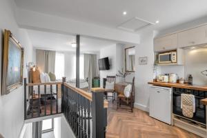 a kitchen and living room with a kitchen and a dining room at Magdalen Rest - Cosy 1 Bedr Central Flat W Fully Equipped Kitchen And Free Parking - Ginger And Gold Ltd in Norwich