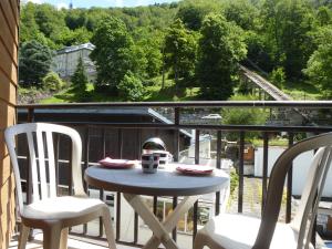 a table and chairs on a balcony with a view at Boost Your Immo Barèges Oncet PM3 in Barèges