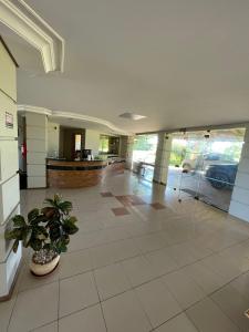 an empty lobby with a potted plant in a building at Executivo Park Hotel in São Borja