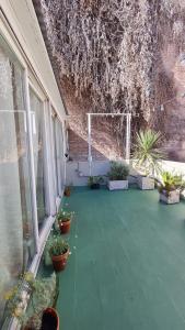 an empty patio with potted plants and a goal at Terracita /mini casa centrica in Mendoza