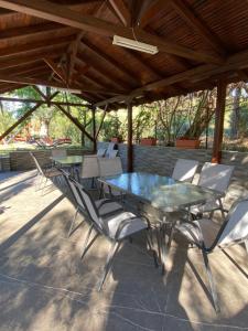 a glass table and chairs on a patio at Elsa Haus in Potos