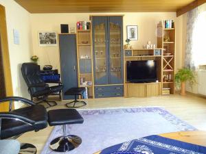 a living room with two chairs and a television at Ferienwohnung Heitzinger in Bad Birnbach