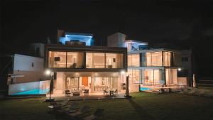 a large house at night with chairs in front of it at Mythical Villas Zeus and Venus in Protaras