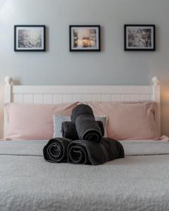 a pile of towels sitting on top of a bed at A beautiful and stylish 2 bed flat close to beach in Bournemouth