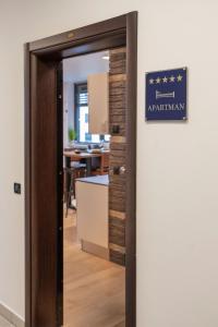an entrance to an office with a sign on a door at New Gallery Best West Apartment 310 in Zagreb