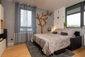 a bedroom with a bed and a clock on the wall at New Gallery Best West Apartment 310 in Zagreb
