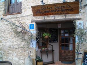 a building with a sign on the side of it at Ca la Serreta in Cretas