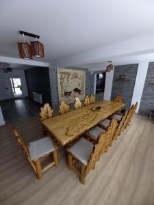 a large wooden table and chairs in a room at Cabana Ioana in Voronet