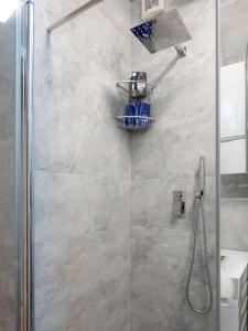 a bathroom with a shower with a glass door at New Gallery Best West Apartment 310 in Zagreb