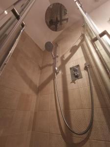 a shower in a bathroom with a shadow on the floor at Prime location for Snowdon, Family and Dog friendly! in Llanberis