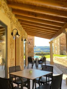 a patio with a table and chairs and a view at Morada Atlántica in A Coruña