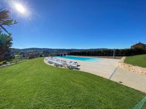 a swimming pool with a row of chairs in a yard at Morada Atlántica in A Coruña