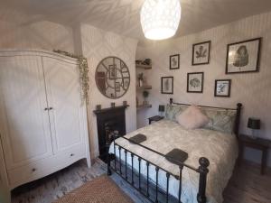 a bedroom with a bed and a chandelier at Prime location for Snowdon, Family and Dog friendly! in Llanberis