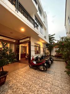 a group of motorcycles parked outside of a building at Queenie House in Can Tho