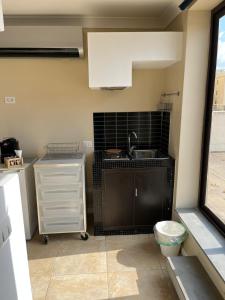 a kitchen with a sink and a toilet at Casual Stay Galileo in Reggio di Calabria