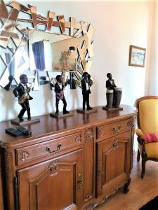 a wooden dresser with figurines on top of it at Vue sur Chateau et Loire in Saumur