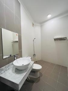 a bathroom with a sink and a toilet at Queenie House in Can Tho