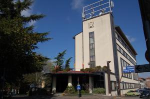 a building with a clock tower on top of it at Balletti Palace Hotel in Viterbo