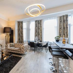 a living room with a couch and a table at Appartement de luxe avec Jacuzzi au centre de Metz in Metz