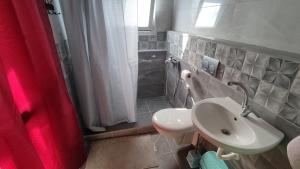 a bathroom with a sink and a toilet at Issa's House in Bayt Sāḩūr