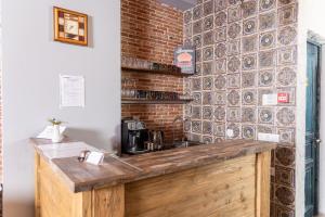 a kitchen with a counter with a brick wall at Rose Hotel Vake in Tbilisi City