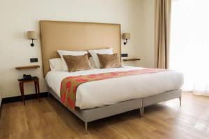 a bedroom with a large bed with a large headboard at FAY Victoria Beach in Rincón de la Victoria