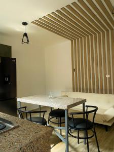 a kitchen with a table and chairs and a couch at Pacific Suites Guayaquil Airport in Guayaquil