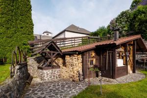 a wooden building with a deck on top of it at Traditional cozy cottage BOCANKA in Nižná Boca