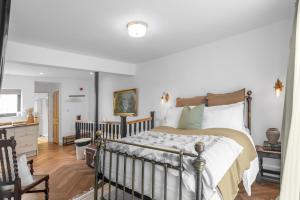 a bedroom with a large bed and a kitchen at Magdalen Rest - Cosy 1 Bedr Central Flat W Fully Equipped Kitchen And Free Parking - Ginger And Gold Ltd in Norwich