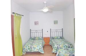 A bed or beds in a room at Apartamento Velarde III Még 7 kép