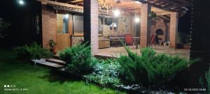 a patio at night with a table and chairs at View Cozia in Călimăneşti