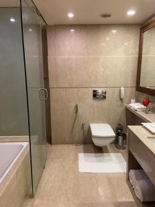 a bathroom with a shower and a toilet and a sink at Fortune Pandiyan Hotel, Madurai - Member ITC's Hotel Group in Madurai