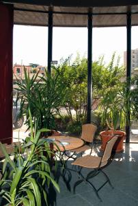 a patio with chairs and potted plants at Balletti Palace Hotel in Viterbo