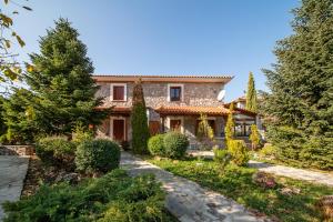 a house with a garden in front of it at Livadi cozy villa in Arachova