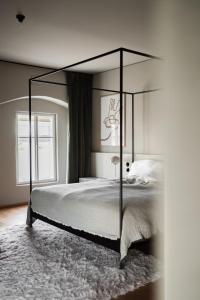 a bedroom with a large bed with a canopy at MÜHLENHOF ROOMS boutique bed & breakfast in Langenlois