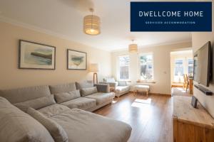 a living room with a couch and a tv at Dwellcome Home Ltd 5 Bed 3 Bath Aberdeen House - see our site for assurance in Aberdeen