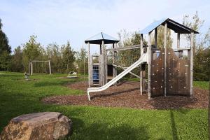 an outdoor playground with a slide and a rock at Schwarzwaldhaus24 - Ferienhaus mit Sauna, Whirlpool und Kamin in Gemeinde Aichhalden