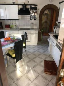 a kitchen with a table and chairs in a kitchen at Ferienwohnung in Golßen/Spreewald, Tropical Island in Golßen